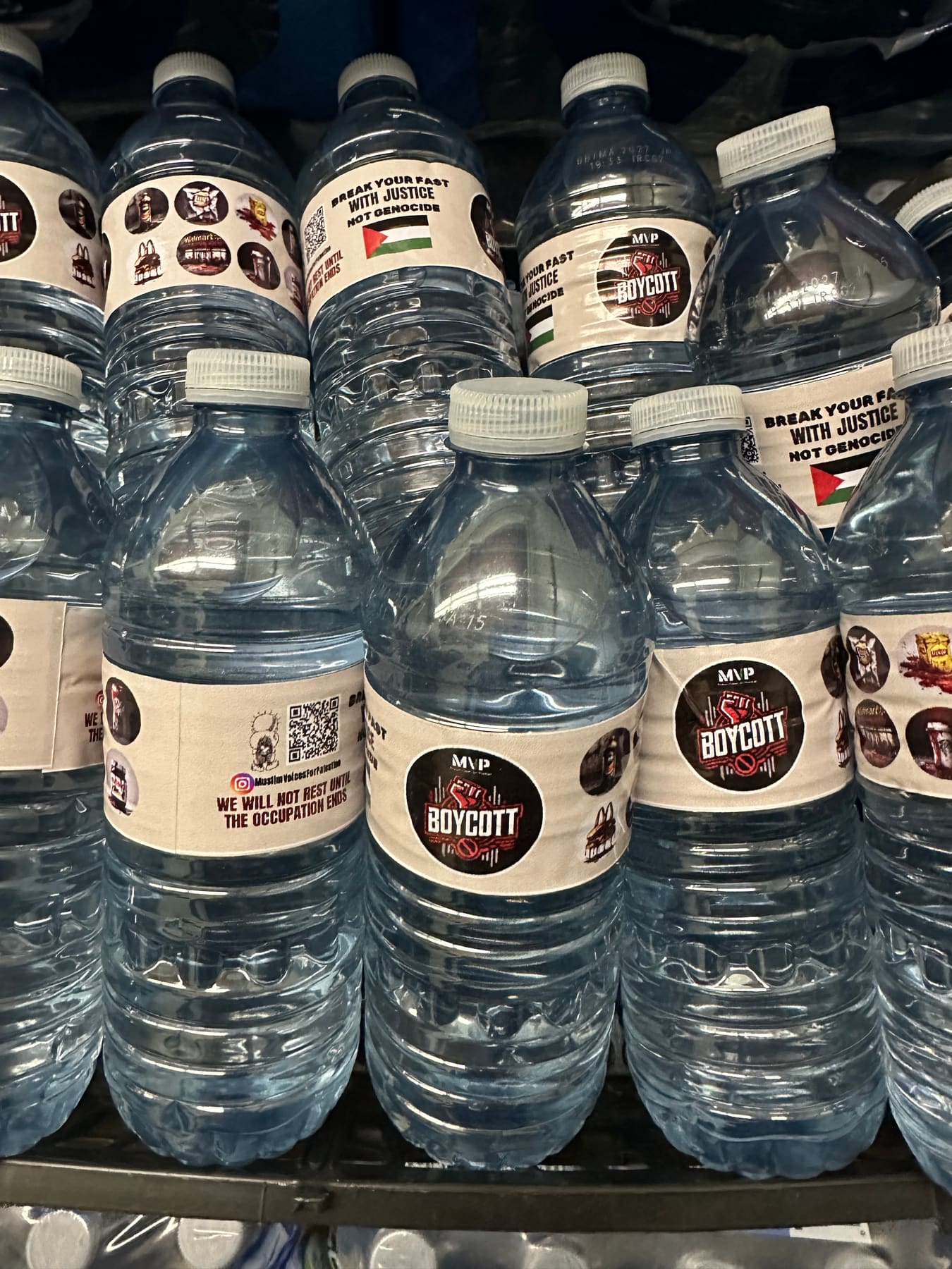 Rows of water bottles with MVP “Boycott” and “Break your fast with justice, not genocide” labels