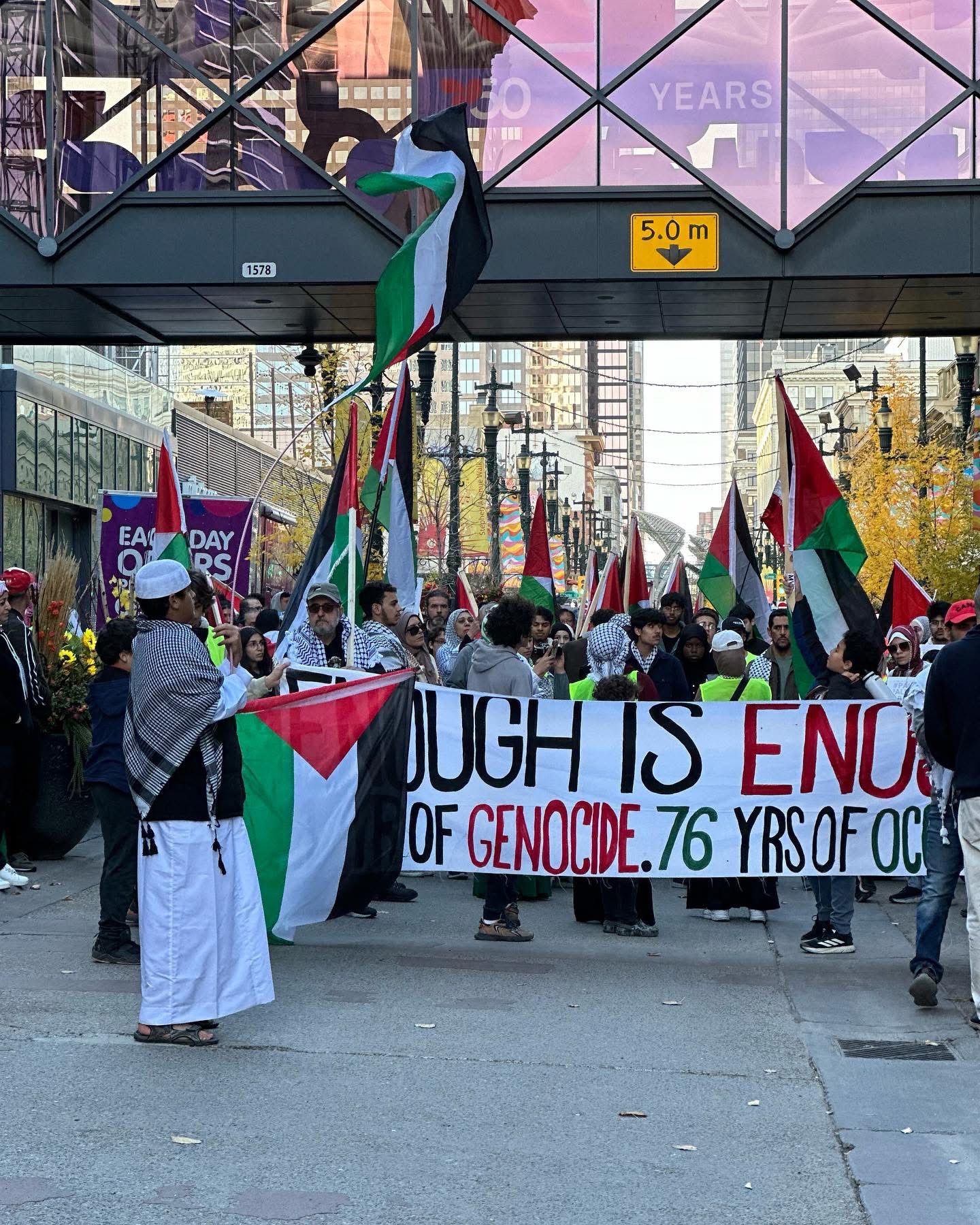 Marchers behind an “Enough is Enough” banner in downtown Calgary